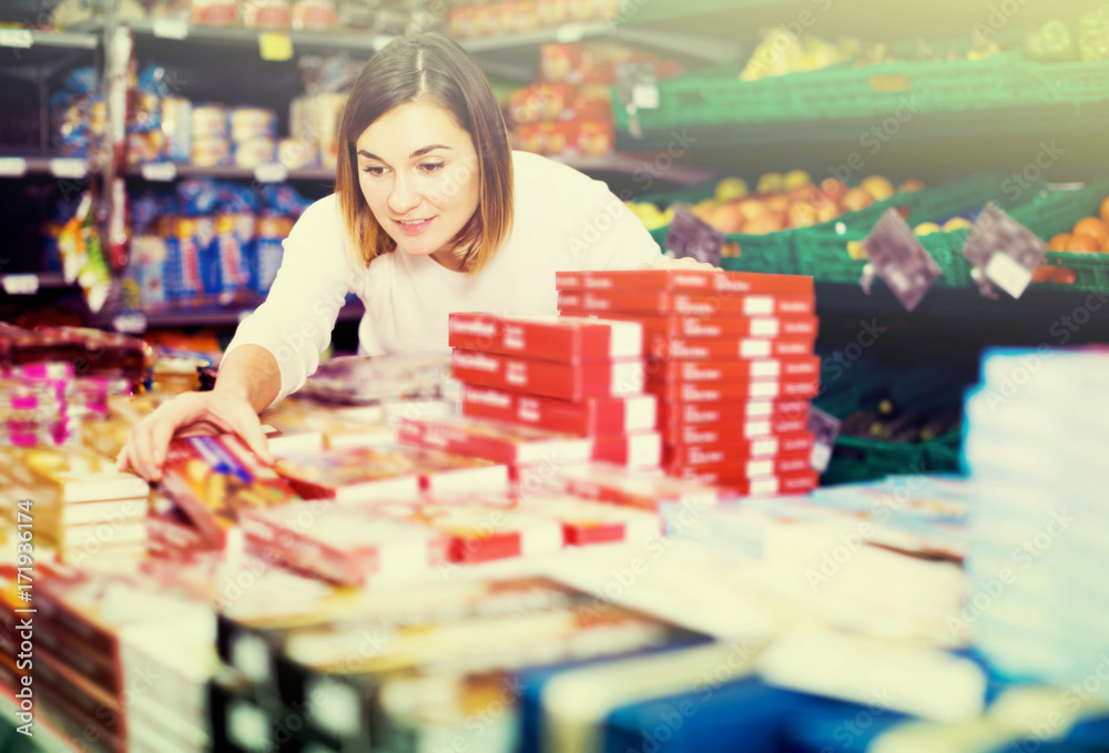 Fototapeta premium Female shopper searching for sweets