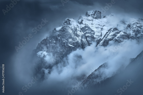 Moody foggy scene on mountain peaks in Tyrol