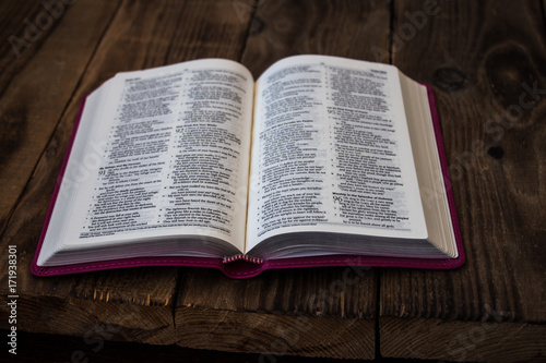 open bible on wooden table