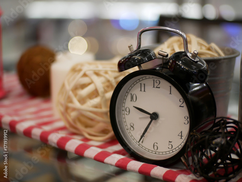 lantern candle and alarm clock with red and white fabric artificial flowers bouquet home decoration concept on bokeh background