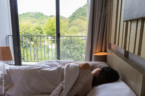 woman resting on the bed and watching the beautiful nature © pnsam