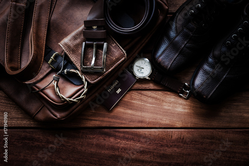 Men's leather accessories and passport on rustic wooden background, fashion and beauty, travel concept photo