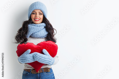 Woman in hat holding heart