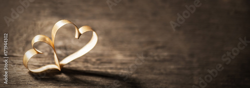 Two ribbon hearts on wood