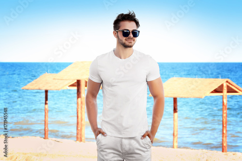 Handsome young man on beach