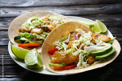 Photography Plate with tasty fish tacos on wooden table