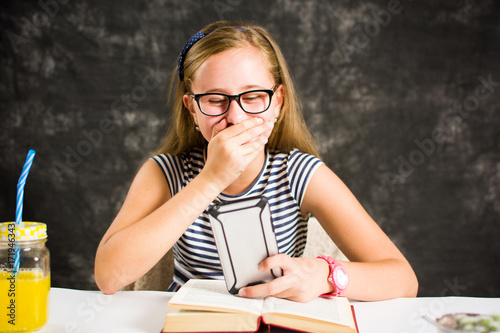 Happy teen girl reading a text