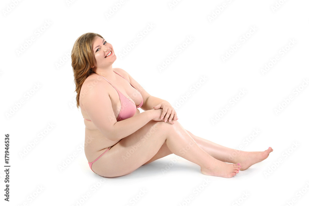 Fototapeta premium Overweight woman in swimsuit posing on white background