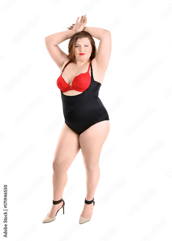 Overweight woman in beautiful underwear posing on white background