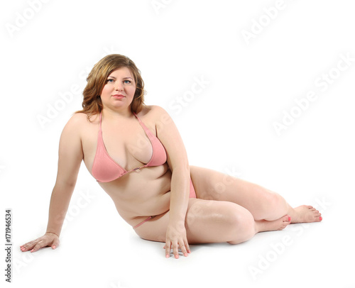 Fotografie Overweight woman in swimsuit posing on white background