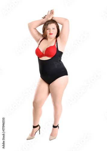 Overweight woman in beautiful underwear posing on white background