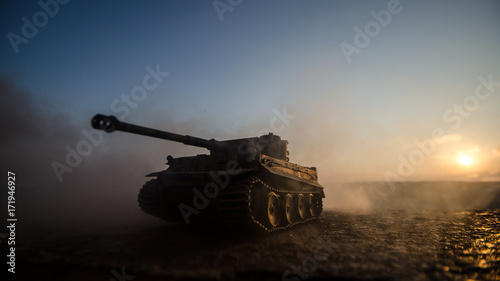 War Concept. Military silhouettes fighting scene on war fog sky background, World War Soldiers Silhouettes Below Cloudy Skyline at sunset. Armored vehicles. German tank in action photo