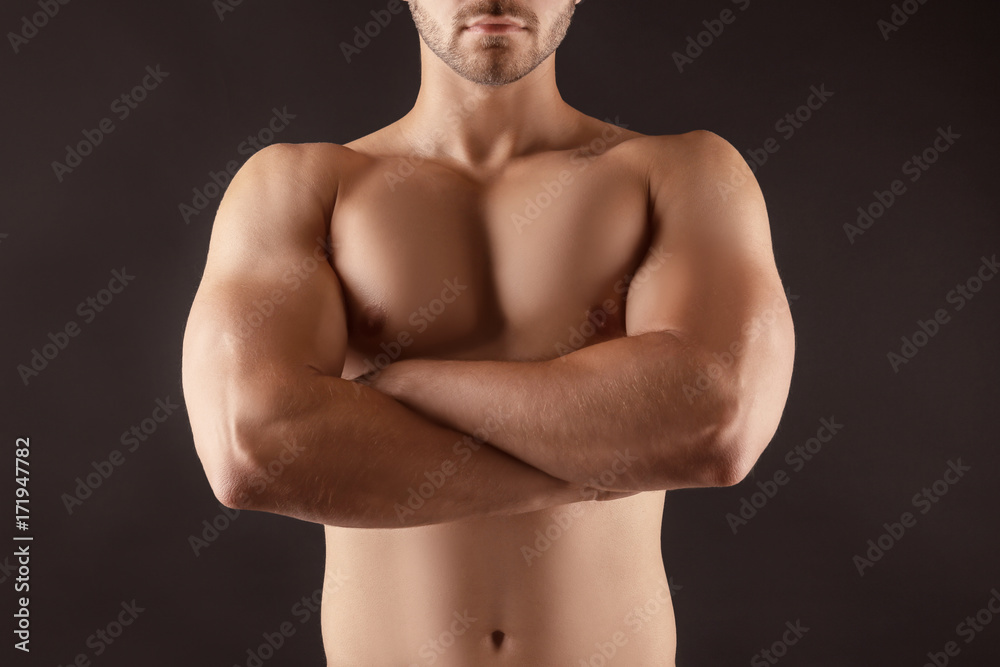 Fototapeta premium Sporty young man on dark background