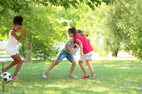 Cute children playing footb...