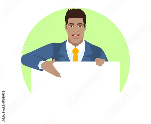Businessman holding white blank poster