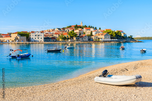 Dingy boat on idyllic beach in Primosten town, Dalmatia, Croatia photo