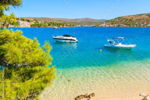 Boats on sea and beach with turquoise crystal clear sea water in Rogoznica town, Dalmatia, Croatia
