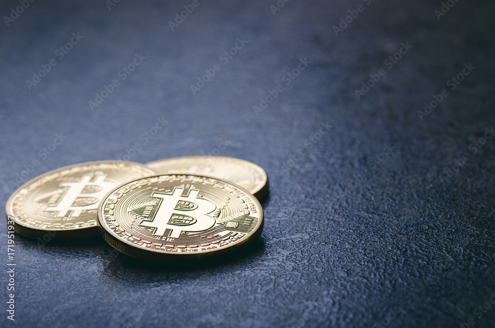Golden bitcoin coins on a dark background with reflection. Virtual currency. Crypto currency. New virtual money. Lens flare Golden bitcoin coins on a dark background with reflection. Virtual currency. Crypto currency. New virtual money. Lens flare