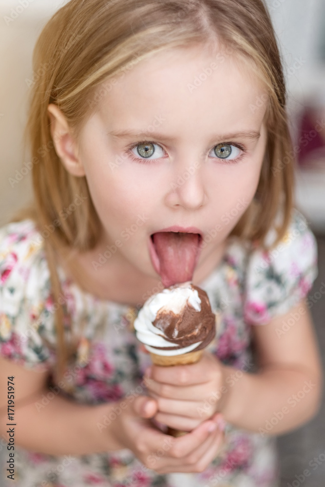 Cute little girl eating ice cream Stock Photo | Adobe Stock