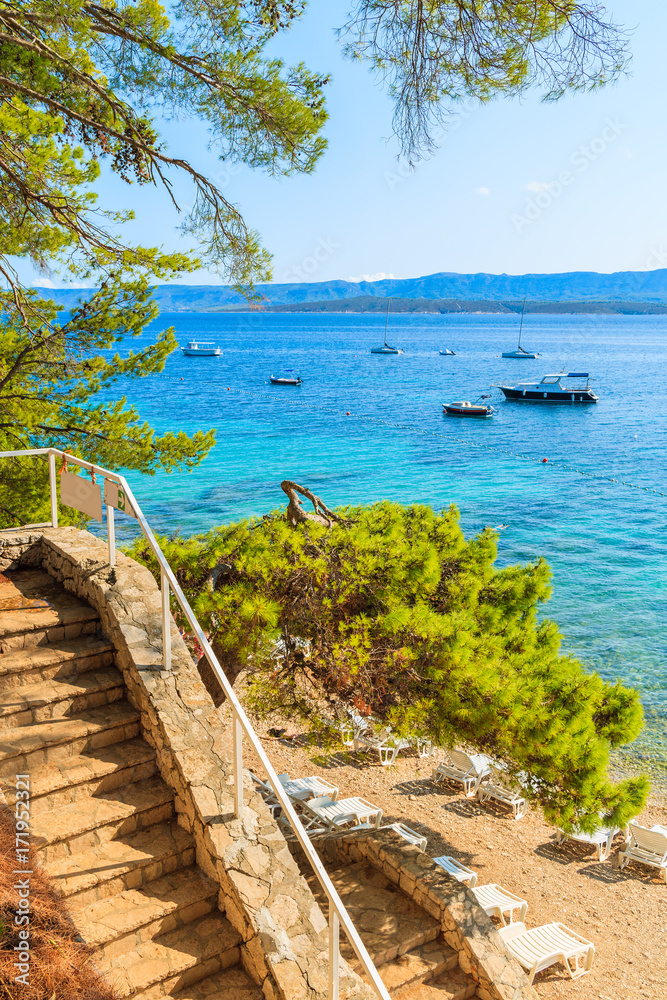 Naklejka premium Steps to wonderful beach with turquoise sea water in Bol town, Brac island, Croatia