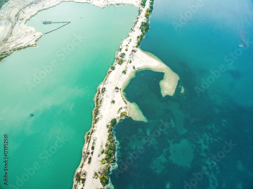 Aerial view - narrow strip of sandy shore and green and blue water