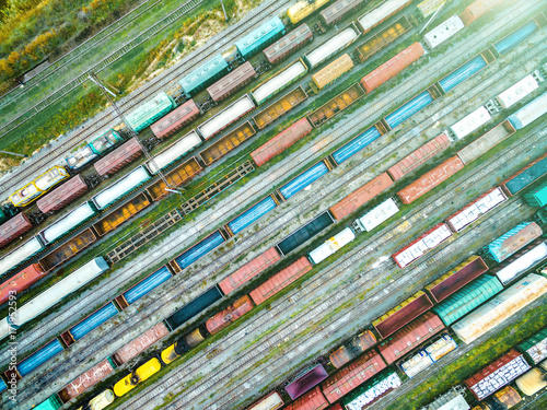 aerial shoot of railway tracks with lots of colorful train wagons