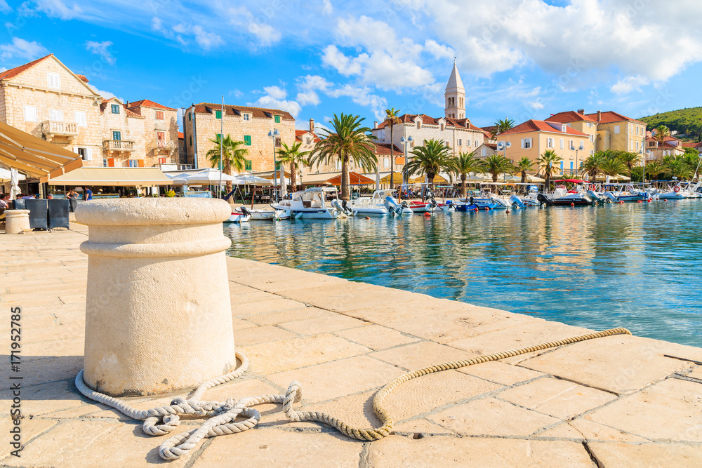 Obraz premium Pier in Supetar port with colorful houses and boats, Brac island, Croatia