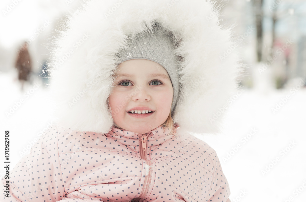 Smiling little girl on sled in winter Smiling little girl on sled in winter