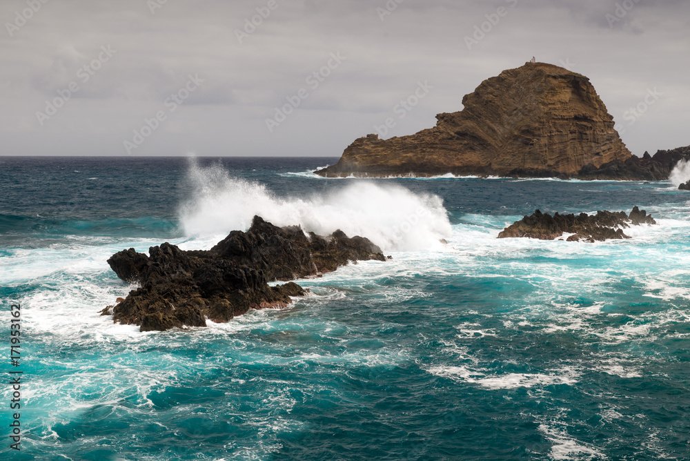 waves of the atlantic ocean hit rocks on the coast of Madeira Island