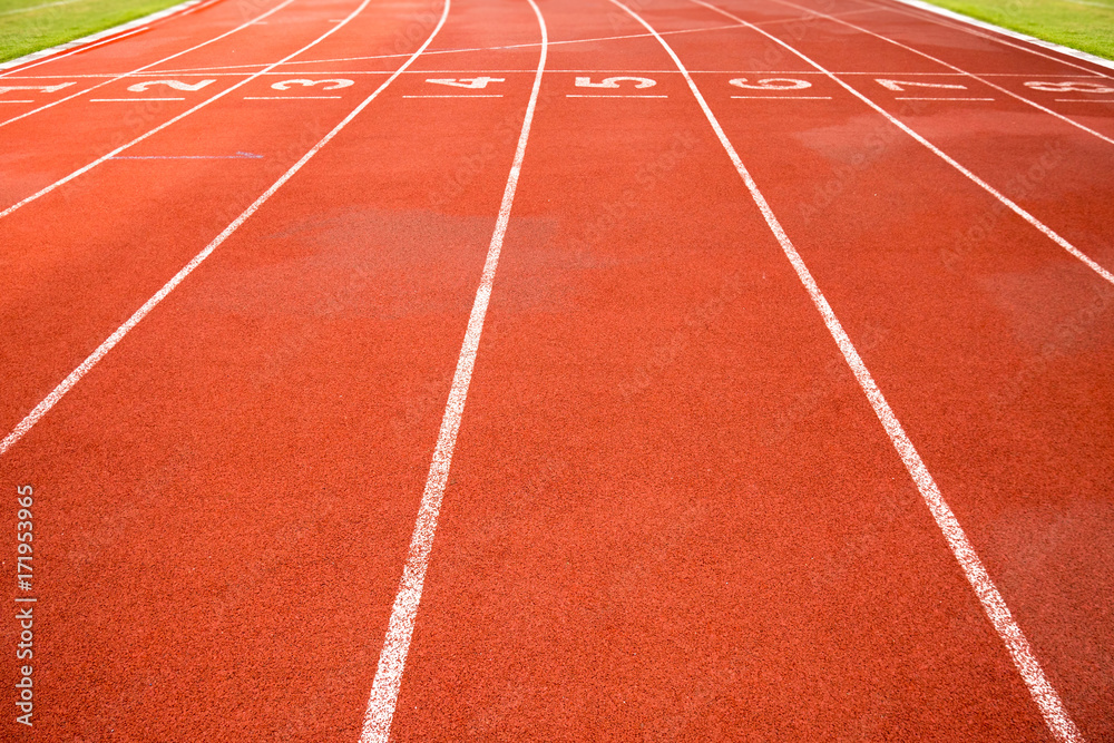Sport, game, competition and exercise concept.red rubber racetracks running lane with number and line in white color. Jogging track, outdoor stadium for running practice and race