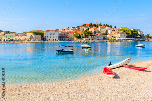 Kayaks and boats on beach in Primosten town, Dalmatia, Croatia