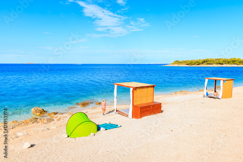 Green tent and unidentified woman on beautiful beach in Primosten town  Dalmatia  Croatia