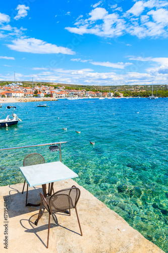 Table of small coastal restaurant on pier in Primosten port, Dalmatia, Croatia