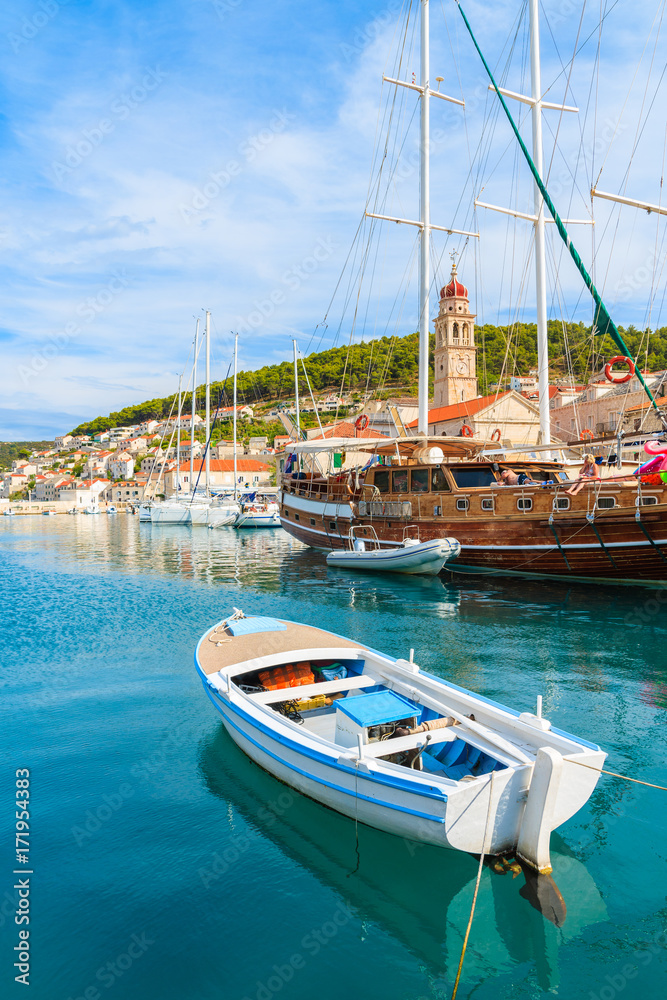 Obraz premium Fishing boat and wooden yacht in Pucisca port, Brac island, Croatia