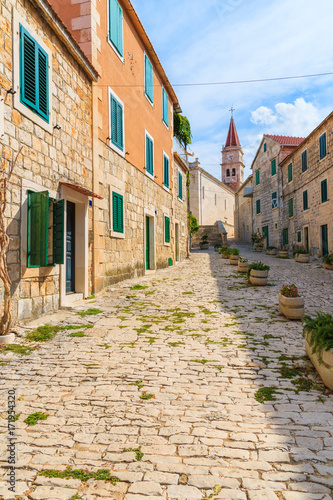 Street with typical stone houses in Postira old town  Brac island  Croatia
