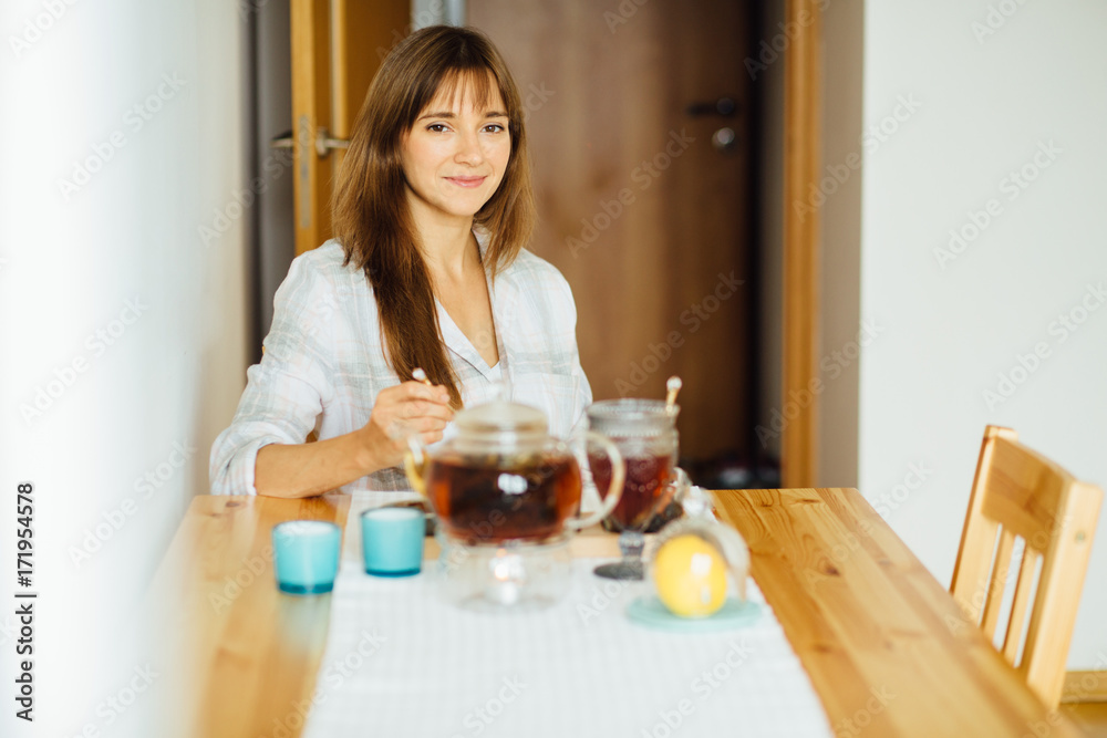 Gorgeous woman sitting by table in the kitchen and ready to have meal. Concept healthy lifestyle in modern family. Gorgeous woman sitting by table in the kitchen and ready to have meal. Concept healthy lifestyle in modern family.