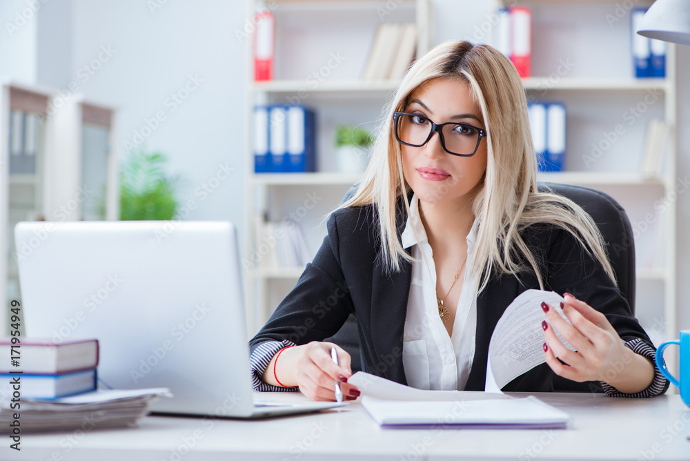 Businesswoman working on laptop at the desk in the office Businesswoman working on laptop at the desk in the office