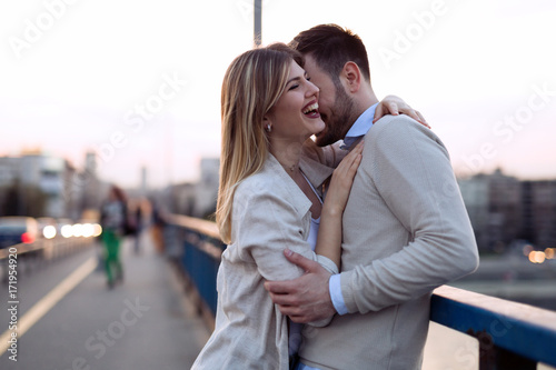 Happy romantic couple hugging and smiling