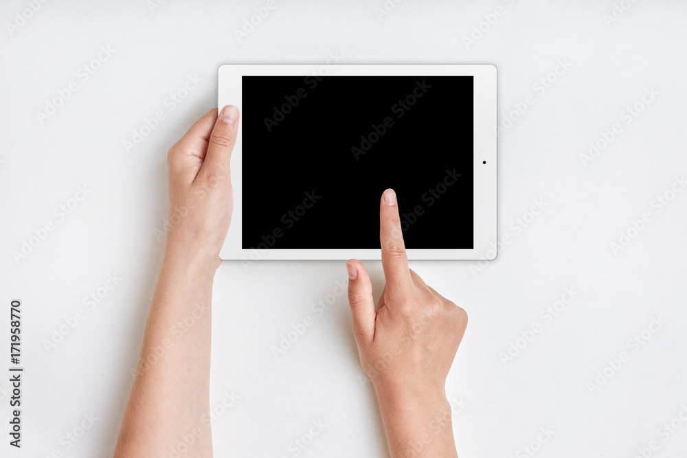 Female hands holds tablet computer with blank screen over white background. Hand touches blank screen of tablet computer. People, modern technologies concept. Woman uses tablet for advertising Female hands holds tablet computer with blank screen over white background. Hand touches blank screen of tablet computer. People, modern technologies concept. Woman uses tablet for advertising