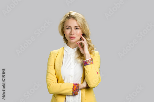 Portrait of attractive woman, grey background. Confident professional office manager woman standing on grey background. Pretty female model.