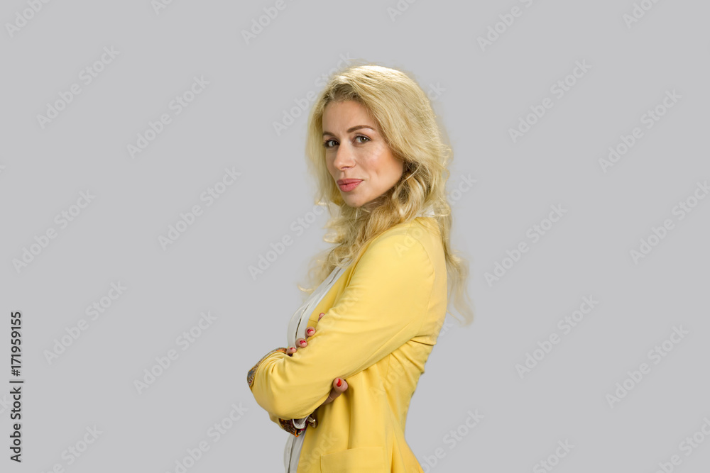 Girl crossed arms, grey background. Beautiful young woman crossed arms isolated on grey backgrund, side profile. Girl crossed arms, grey background. Beautiful young woman crossed arms isolated on grey backgrund, side profile.