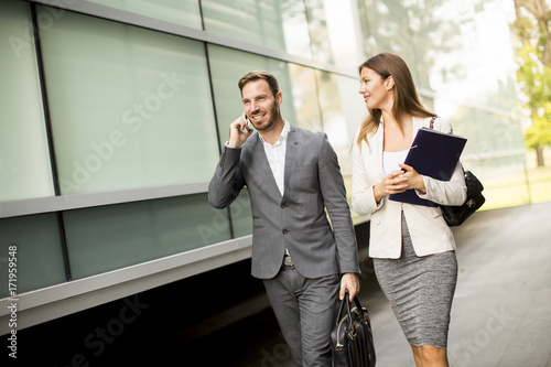 Young business couple walki...