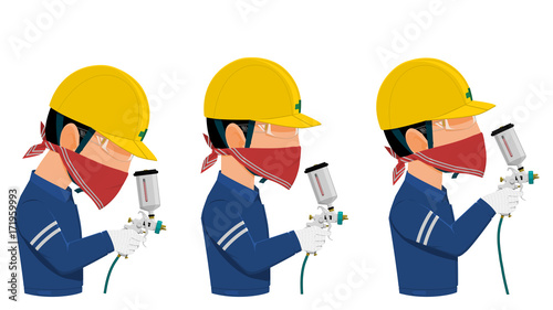 Painter with safety glasses and red handkerchief is using spray gun
