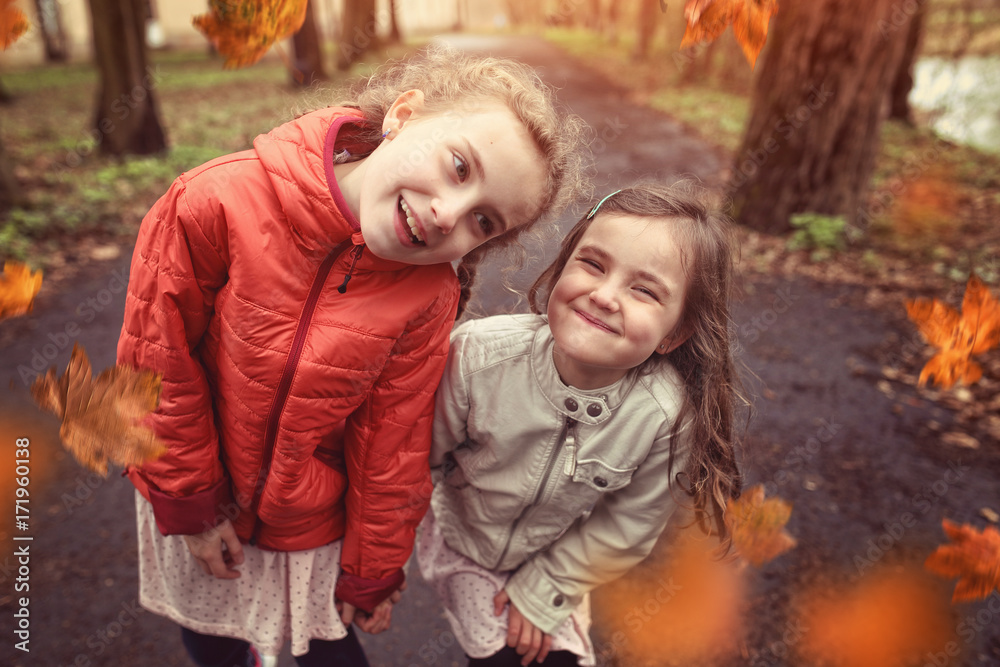Fototapeta premium Friendship of two young girls in autumn day