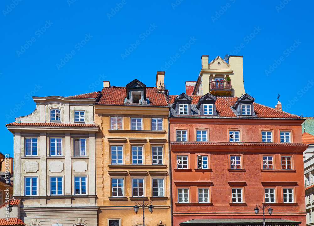 Facades of three buildings in the old town in Warsaw, Poland