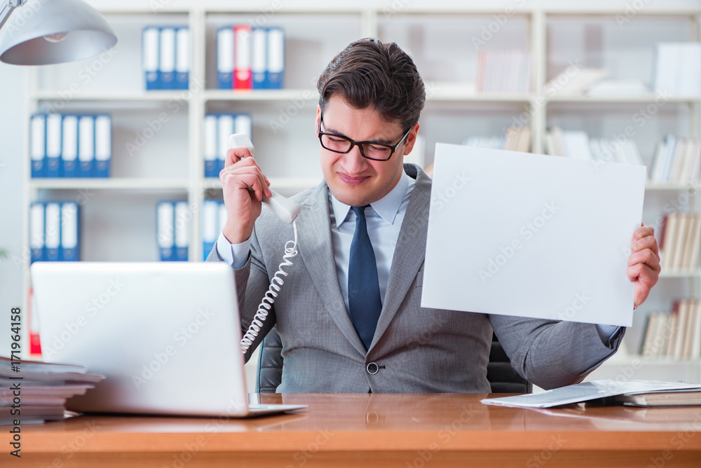 Businessman in office holding a blank message board Businessman in office holding a blank message board