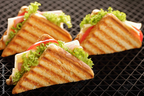 Fresh sandwiches on black background
