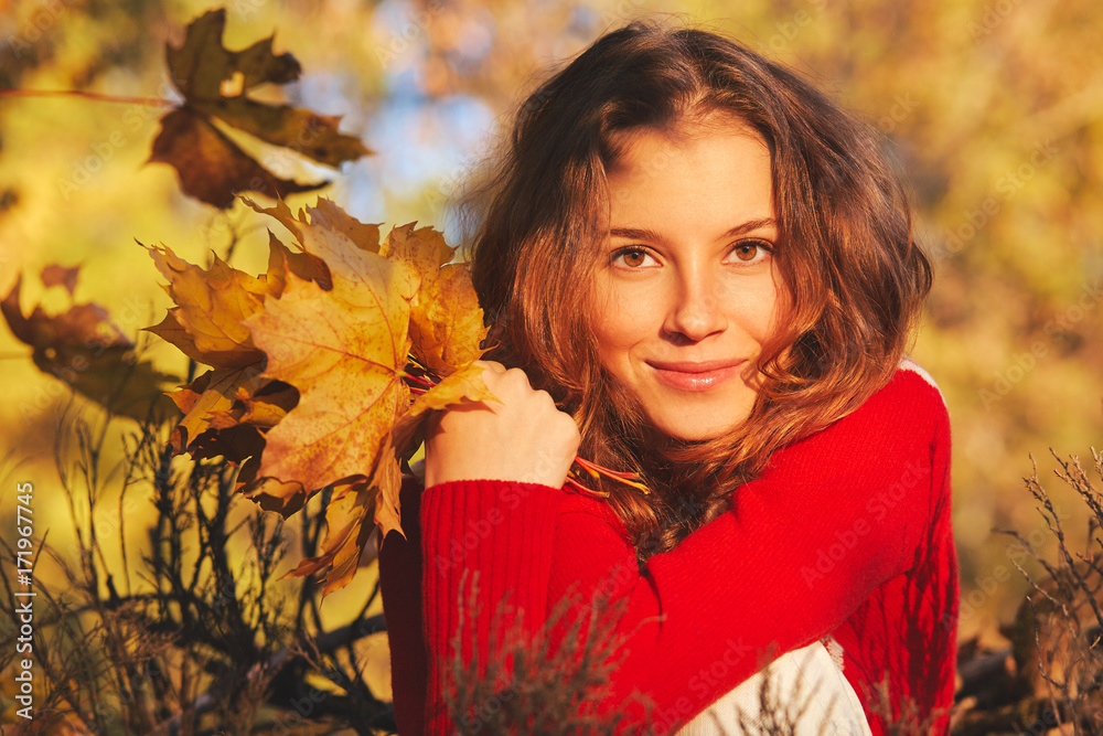 Beautiful young woman in red sweater in autumn park Beautiful young woman in red sweater in autumn park