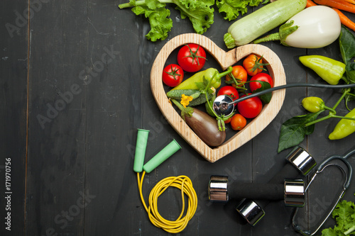 Diet. Sport and a healthy lifestyle. Fresh vegetables on a black wooden background