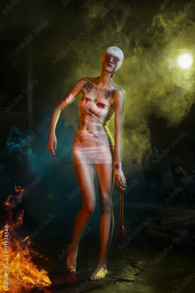halloween bloody zombie girl with the axe in hand